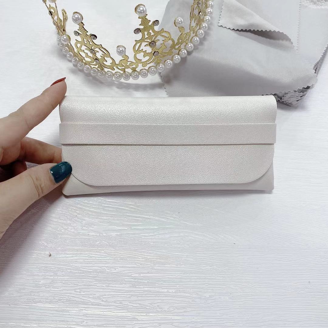 Elegant white PU sunglasses storage case held by hand, perfect for organizing and protecting your eyewear.