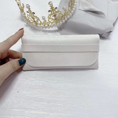 Elegant white PU sunglasses storage case held by hand, perfect for organizing and protecting your eyewear.