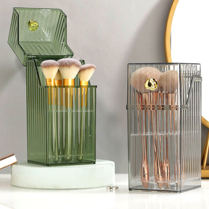 Stylish vanity brush storage bucket with gold-accented brushes in green and gray containers, ideal for desktop organization.