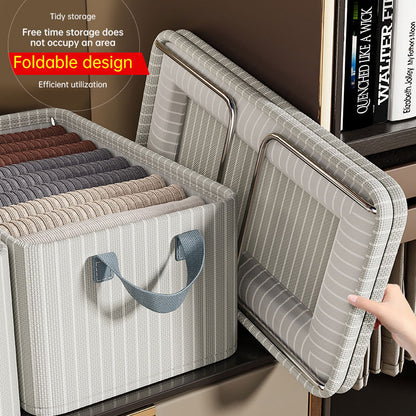 Striped Oxford cloth storage box with foldable design, showcasing organized clothing storage and reinforced handles.