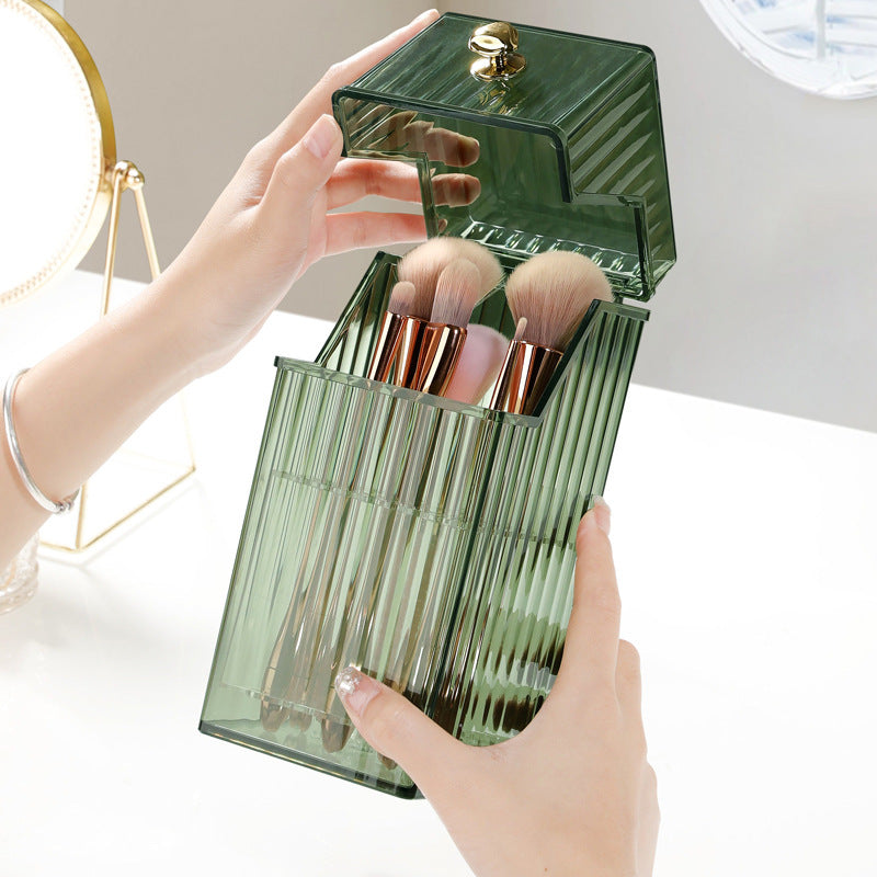 Green vanity brush storage box with built-in cosmetic brush holder, elegantly displayed on a desktop.
